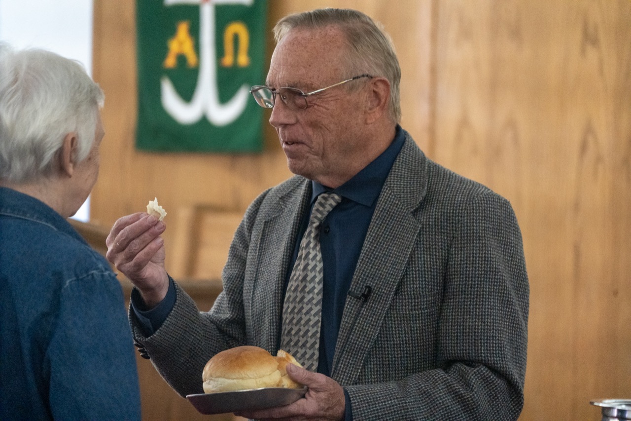 Vicar Kim Bate sharing communion bread during a worship service at Beautiful Savior Lutheran Church.