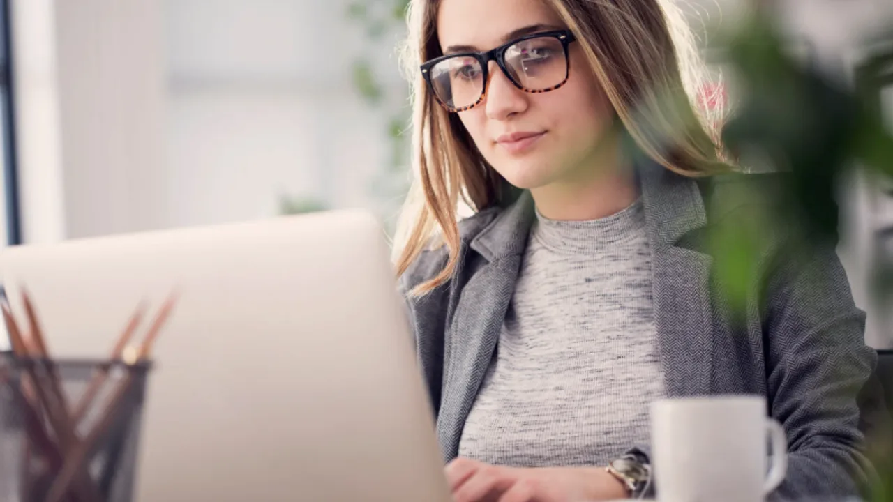 Attorney working at a desk with legal documents and a laptop.