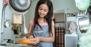 Teenager doing dishes as an example of how Best Practices for ChatGPT Prompts for Coaches and Consultants can be used