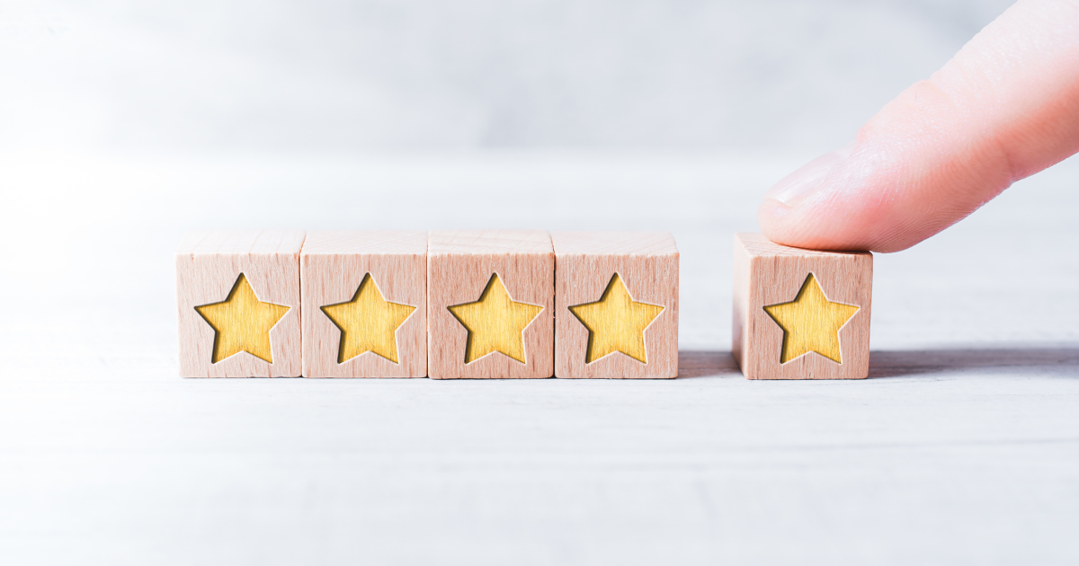 5 wood blocks with stars on them illustrating a review.
